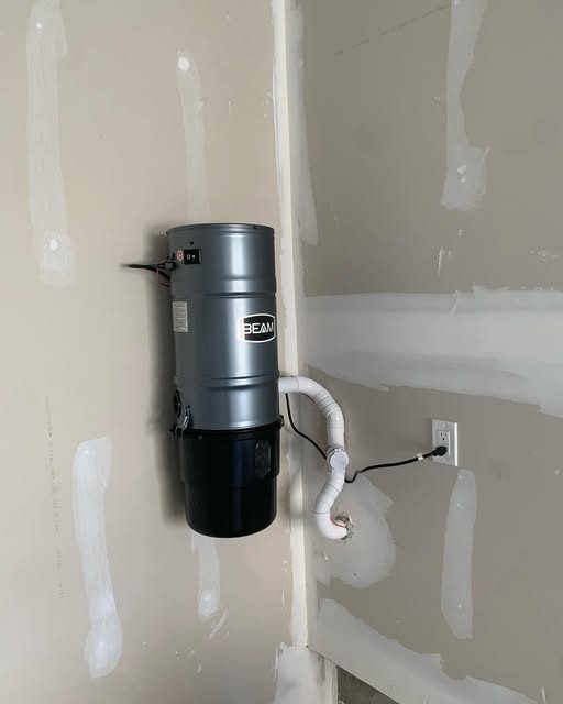 Central vacuum power unit installed with piping and dedicated outlet
